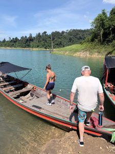 Couple boarding a long tail boat at the Cheow Lan Lake in Khao Sok.