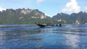 Long-tail boat crossing the Cheow Lan Lake in Khao Sok.